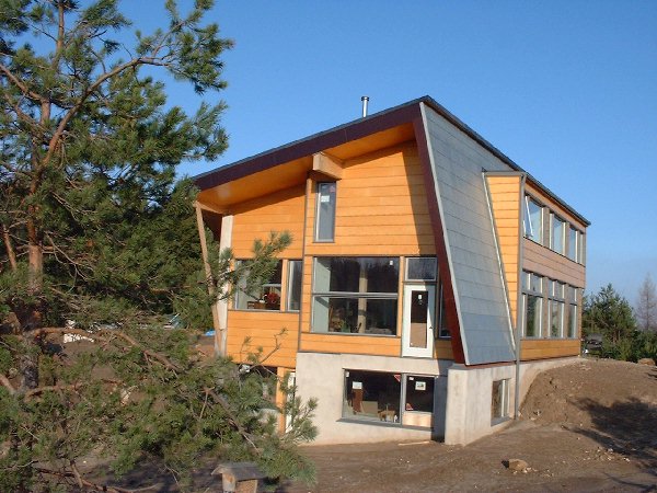 The west end of the house soaks up the late afternoon sun on a cool sunny day. Inside the house has collected the heat in the concrete floors. In fact it was so hot that I had to open some windows to 