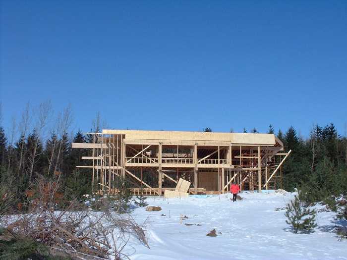 A lady in pink, my mother, explores. The south face of the structure is now mostly complete.