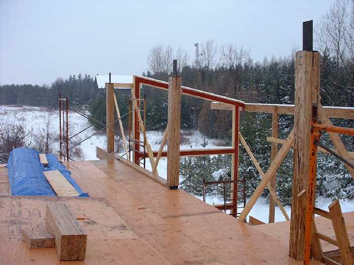 Up on the second floor the new posts stand ready for a new beam that will eventually hold the joists for the roof. Snow and ice cover the structure as the weather gets warmer but still near freezing. 