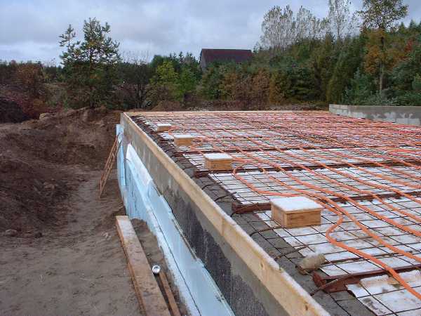 Looking west down into basement. The square wooden boxes will provide the forming for the tempered glass windows which will be placed in the concrete floor. This brilliant design idea that Martin sugg