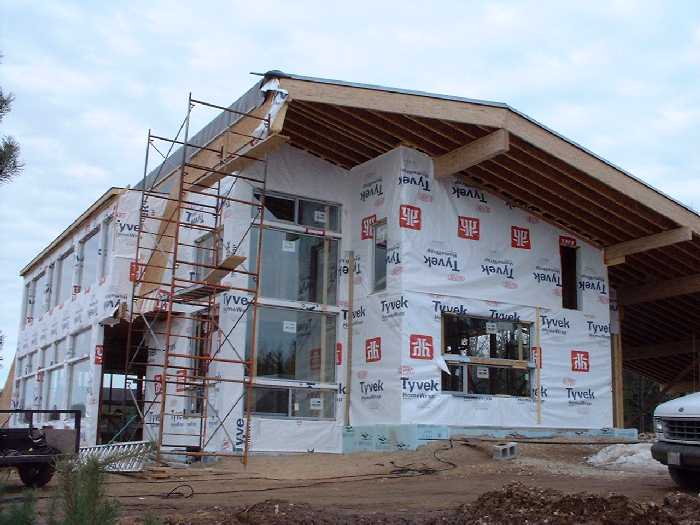 On the east side of the house, you can see the "greenhouse" windows rising up 2 storeys. A walk-out to the south provides access to a protected area of the yard.