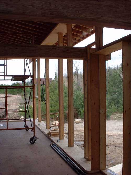 The north wall has been prepared for the straw bale walls with play wood on top and bottom at a width of about 18 inches. At the far end, in the wall are the steel cross bars designed to reinforce the
