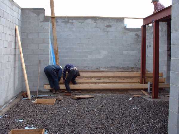 October 4 , 2000 - The basement floor is ready to have steel lattice and then the water pipes laid out for in floor heating. Steps are formed for easy access to the central composting toil system area