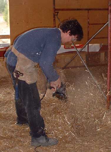 Chris sculps the bale to allow for a close fit around the steel cross beams.