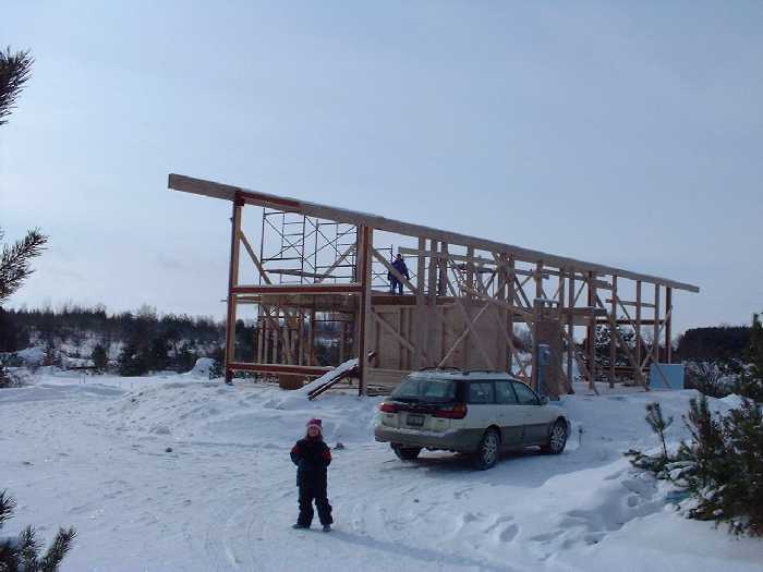 December 23 , 2000 - Claire in the foreground and Leigh up on the second floor. The car is parked where the car port will go eventually.