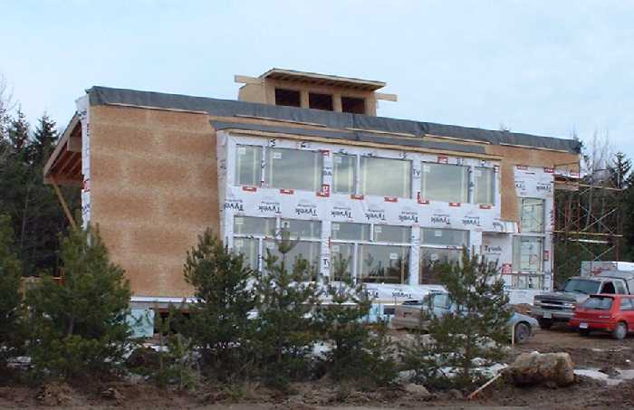 The expanse of windows on the south side will bring in plenty of sunlight to provide light and passive solar heating. The heat of the sun will be absorbed by the concrete floors, which have water tubi
