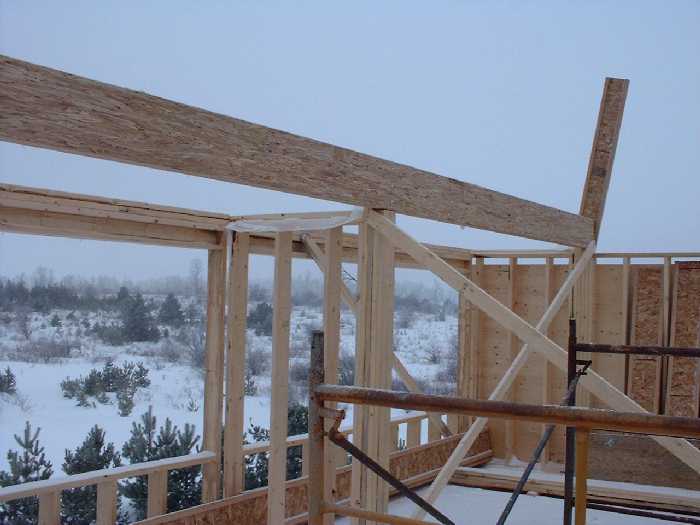 The second floors angled wall and the highest point of the ceiling are visible in the upper right portion of this picture. The solar panels will site in this step in the roof. Small windows may provid