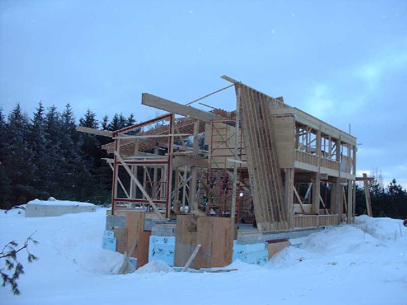 The south face of the house takes shape. The angled wall will be covered in zinc metal siding which has a greenish silver colour. Very natural looking.