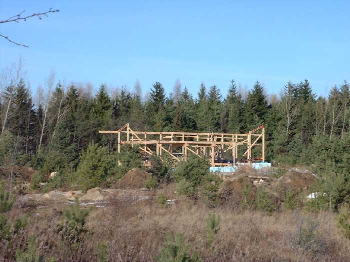 The sun shines down into the house which is nestled into the trees. The trees are on the north side providing a wind break from the constant northern cold breezes. The land slopes gently from the nort