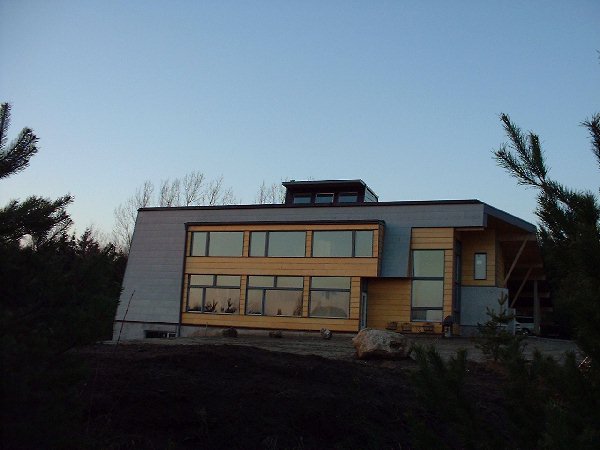 The sun sets slowly casting a dark orange glow on the windows.