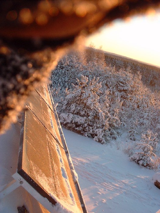 December 17 , 2002 - Up on the roof you can see a close-up of the solar panels. This was a cold, frosty, but fortunately sunny day. It is nice to know that the output from solar panels increases the l
