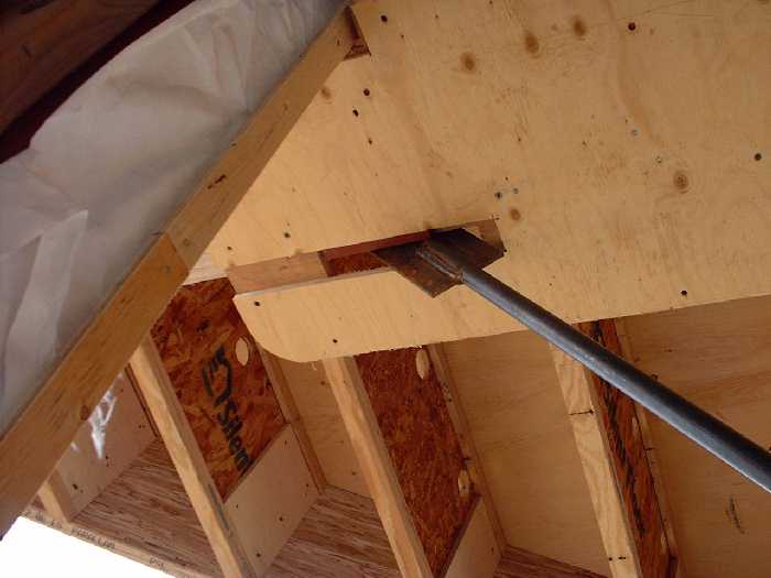 The steel bars are secured at the top and bottom of the wall.