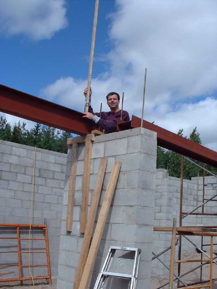 Using a transit we make sure that the beam is at the correct relative height.