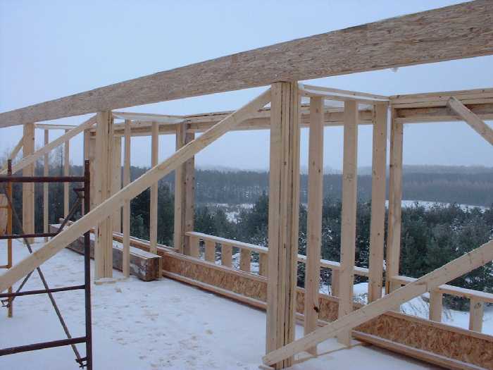 Three bedrooms on the second floor have their window frames and the start of dividing walls.