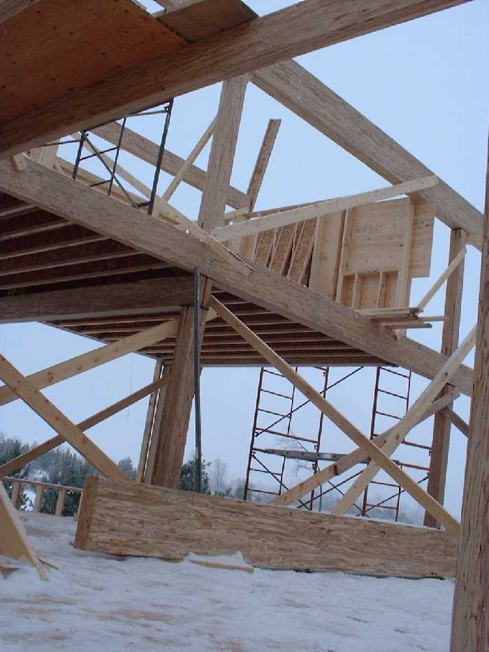 Looking up at the second floor from the kitchen. A joist beam shows where the ceiling will eventually peak.