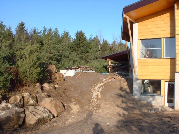 The rock drainage path directs the large amount of water which currently flows off of the large EPDM covered roof. Once the soil and grasses are established on the roof we expect the flow to be signif