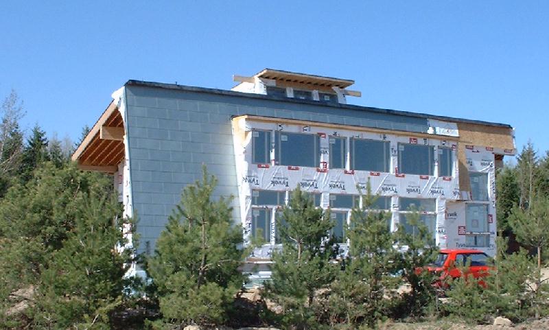 The zinc siding begins to reflect the sky.
