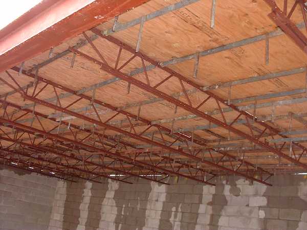 The joists are ready in the basement. Tyvek was added after this picture was taken to create a smooth ceiling finish.