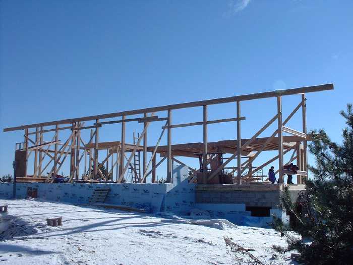 Looking south east from the north east corner. The second floor is visible in the middle of the house. A ladder shows where the bathroom on the 2nd floor will be in future.