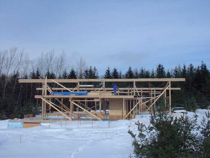 The second floor central beam is in place. Leigh stands in what will be a bedroom on the second floor. The view to the south is gorgeous.
