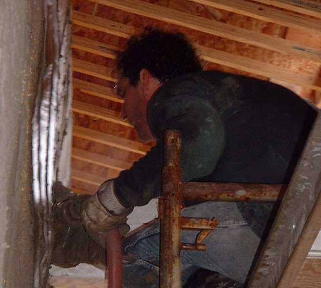 Close-up of Bill working hard with the new automatic plaster trowel.