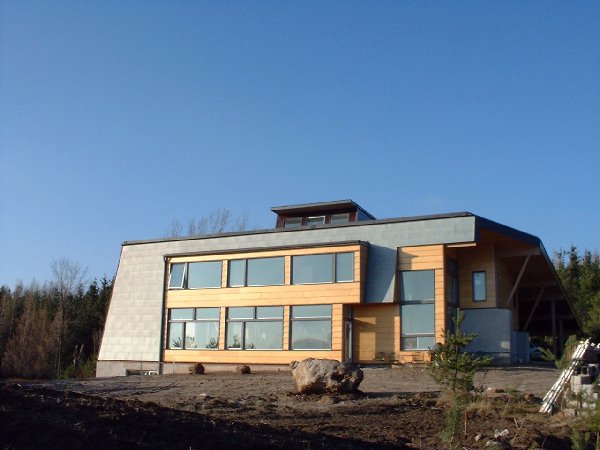 The house soaks up the sun on a cool December afternoon. The boulders are the remains of ancient glacial activity in this heavenly hilltop location.