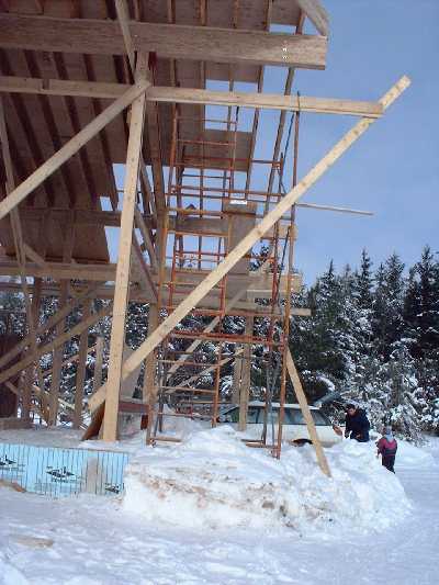 The east side of the roof gets final pieces of plywood.