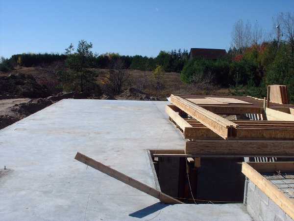 October 16 , 2000 - The ground floor on the east side looking west. The in-floor heating system has been covered in concrete and smooth floor remains as the final surface.