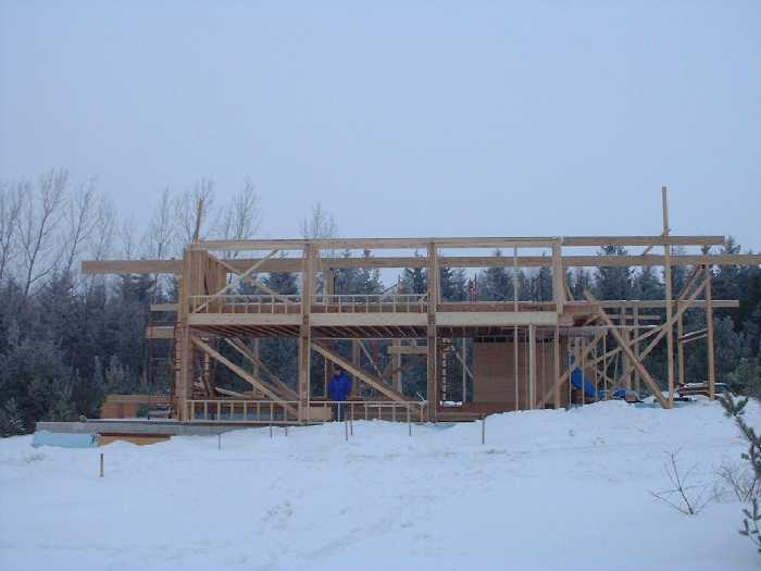 Window frames are visible on both the ground and second floor. The main floor on the south side shapes up to be a large green house.