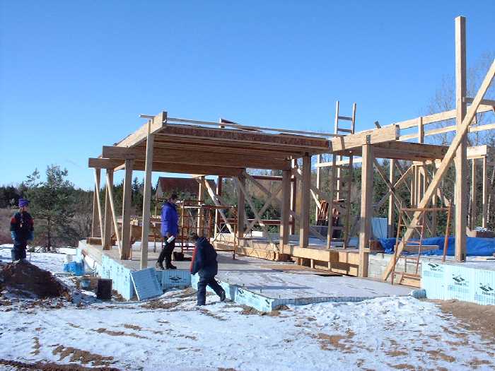 December 2 , 2000 - The kids play around the newly installed septic system and we can see the joists for the second floor along the south side of the house. These will provide the floor for the three 