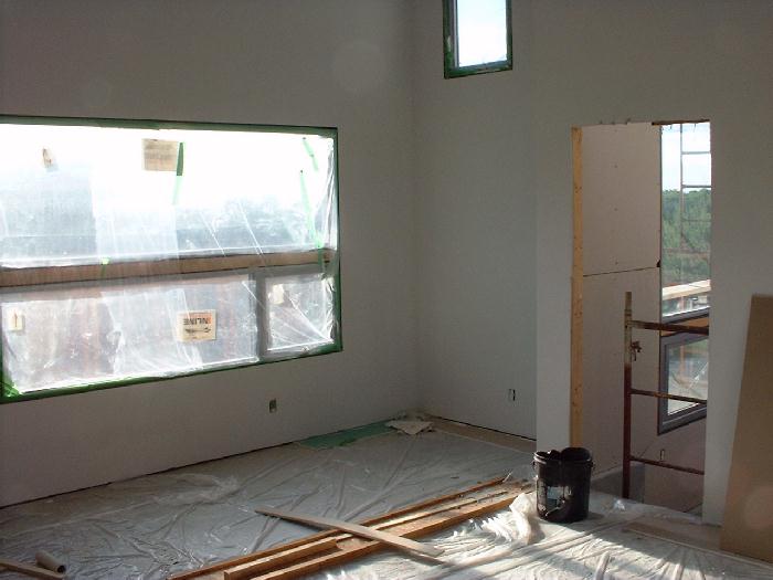 Leigh and John have painted the master bedroom. The door on the right leads into the greenhouse.