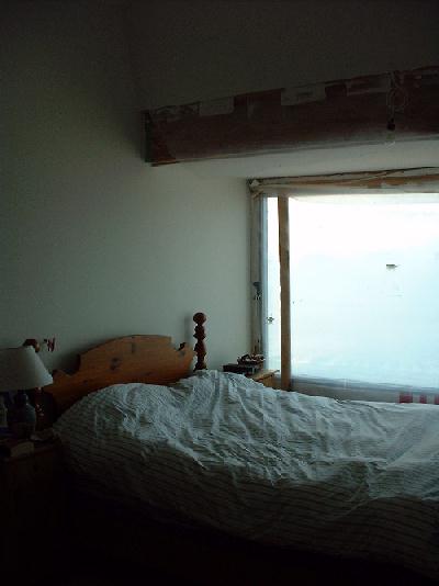 The spare bedroom on the second floor. Windows are still covered with poly plastic sheets to keep the rain out until the windows is set in it's final place.