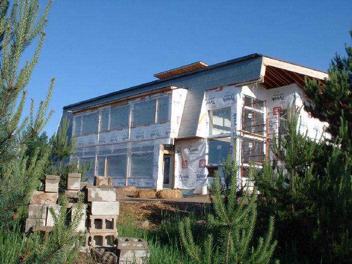 The bright morning sun lights up the south face of the house.