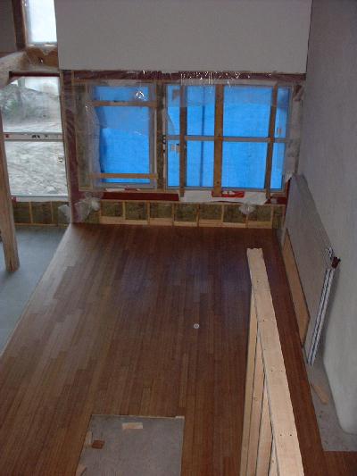 Bamboo flooring in the dining room with a concrete pad prepared for the wood stove.