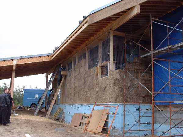 Stacking bales in the corner with a window.
