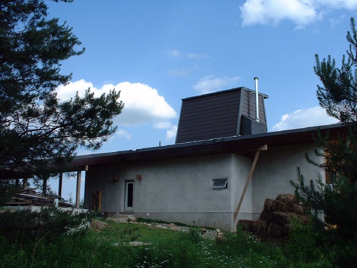 June 28 , 2002 - The north wall of the house has stucco on strawbales for the walls. The left over straw bales have come in very handy in the vegetable garden, for landscaping and for creating paths. 